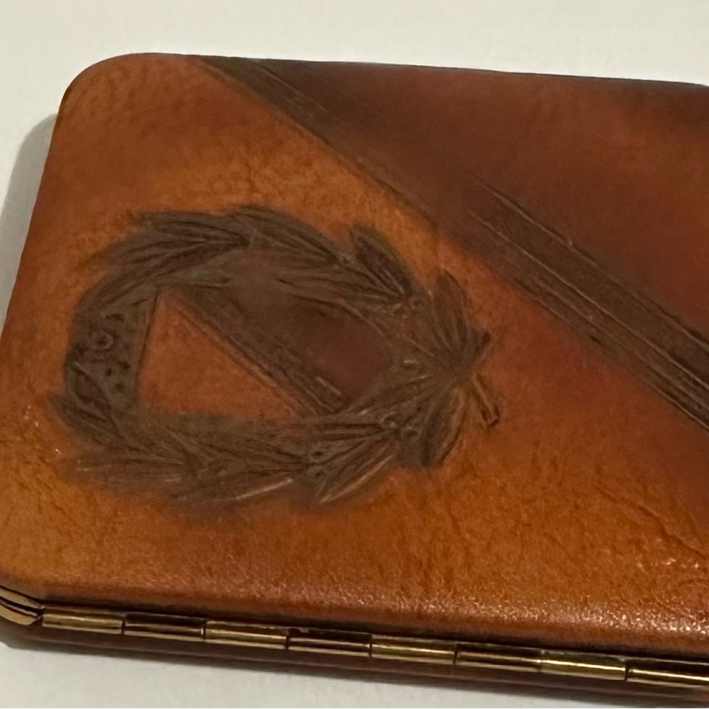 Tooled, leather compact